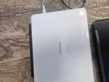 a white laptop and a black laptop on a wooden table