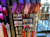 many pairs of socks hanging on a rack in a store