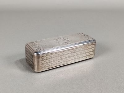 a silver box sitting on a table with a white background