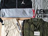 three pairs of men ' s clothing laid out on a cardboard box