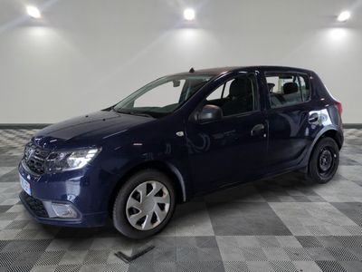 the small blue car is parked in a room with a checkered floor