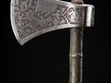 a close up of an old axe on a black background
