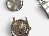 a watch that is sitting next to a watch on a table