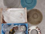 a blue box filled with assorted items sitting on the floor