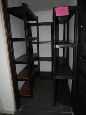 a small room with shelves and a door in it