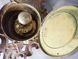 a small metal container with a lid on a table