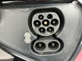 a close up of a car ' s rear view mirror with a plugged in