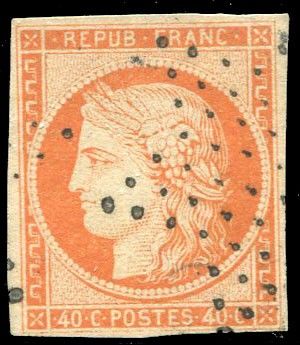 an orange and black stamp with a woman ' s head on it