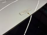 a close up of a car ' s hood with a tag on it