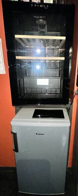 a small refrigerator and a mini fridge in a small room