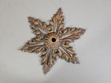 a gold snowflake on a white surface