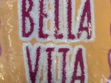 a bag that has a sign on it that says bella vita