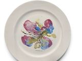 a white plate with a painting of a flower on it