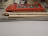 several books are stacked on top of each other on a table