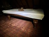 a bed with a white sheet on top of it in a dark room