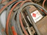a pile of hoses and other equipment in a garage