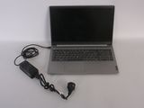 a laptop that is sitting on a table with a charger