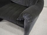 an image of a black chair with a broken arm