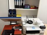 a desk with a printer, printer and other office supplies on it