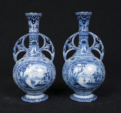 pair of blue and white vases with figures in a landscape