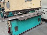 a large machine is sitting in a warehouse with a lot of steel