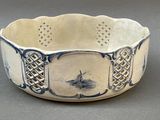 a white bowl with a blue and white design on it