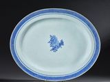 a blue and white plate with a floral design on it