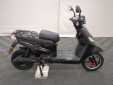 a scooter that is parked on a checkered floor