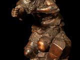 bronze statue of a man holding a football ball on a marble base
