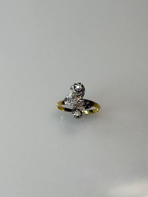 an image of a silver and gold ring on a white surface