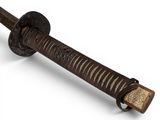 a close up of a sword with a wooden handle on a white surface