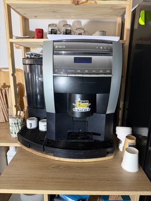 a coffee machine that is sitting on top of a shelf