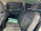 two seats in the back of a car with a remote control