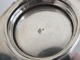 a close up of a silver plate on a table