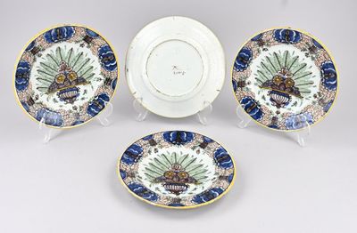 four pieces of blue and white plates with gold trim