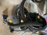 a vacuum that is sitting on the floor next to a bike