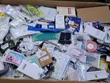 a cardboard box full of electronic devices and other items