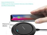 an image of a person holding a phone and charging a wireless device