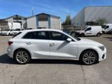 the white car is parked in a parking lot with other cars