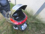 a scooter that is parked next to a building