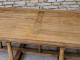 a wooden table with a wooden top on a cement floor