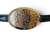 a belt with a gold buckle on it on a white surface