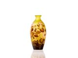 a yellow vase that is sitting on a white surface