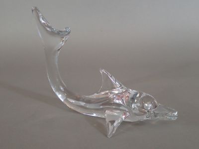 a glass sculpture of a fish on a table