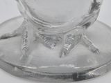 a glass cup with a bird on it on a saucer