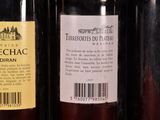 several bottles of wine are lined up on a shelf