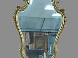 a mirror that is hanging on the wall in the room
