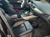 the interior of a car with the door open and the driver ' s seat down