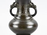 a black vase with a handle on a white background