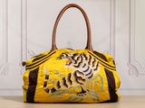 a close up of a handbag with a tiger on it